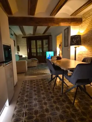 a living room with a wooden table and chairs at Valencia Catedral Apt in Valencia