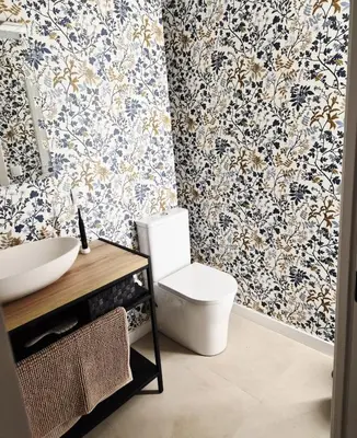 a bathroom with a toilet and floral wallpaper at Valencia Catedral Apt in Valencia