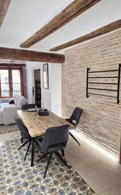a living room with a wooden table and chairs at Valencia Catedral Apt in Valencia