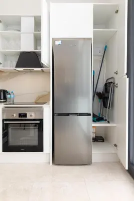 a stainless steel refrigerator in a kitchen with a stove at Portobello Road Suites in Valencia