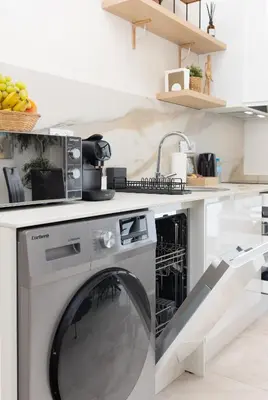 a kitchen with a dishwasher under a counter at Portobello Road Suites in Valencia