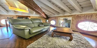 a living room with a couch and a table at Gran Ático Premium del Siglo XVI con Tres Terrazas Privadas Hasta 7 Huéspedes en Ciutat Vella in Valencia