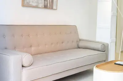 a couch in a living room with a table at VLC Host - Cubells 8 in Valencia