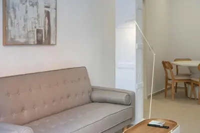a living room with a couch and a table at VLC Host - Cubells 8 in Valencia