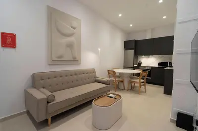 a living room with a couch and a table at VLC Host - Cubells 8 in Valencia