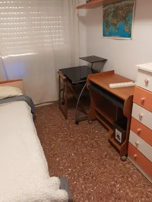 a bedroom with a bed and a desk and a piano at Habitación doble 45eur in Valencia
