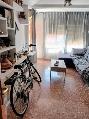 a bike parked in a living room with a couch at Habitación doble 45eur in Valencia