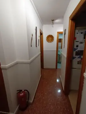 a hallway with white walls and a red floor at Alquilo habitación 24 euros por noche Super Top in Valencia