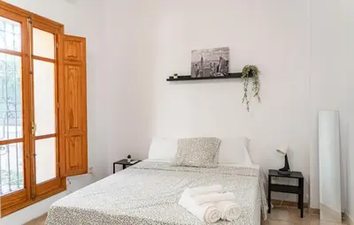 a bedroom with a bed with two towels on it at especial mediterranean room in Valencia