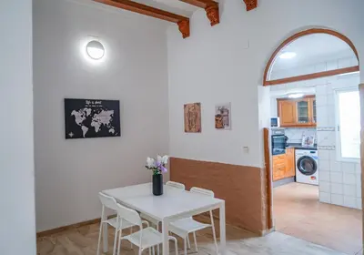 a kitchen and dining room with a white table and chairs at especial mediterranean room in Valencia