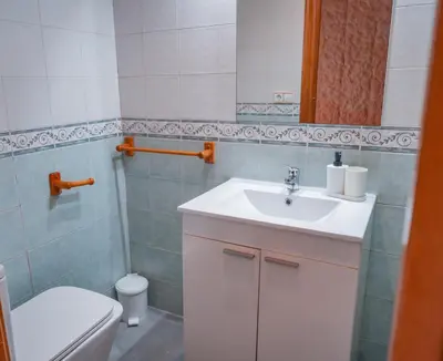 a bathroom with a sink and a toilet at especial mediterranean room in Valencia
