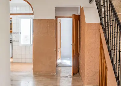 a hallway with an open door in a house at especial mediterranean room in Valencia