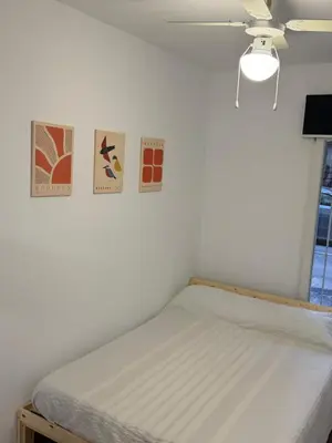 a bed in a room with three pictures on the wall at Apartamento junto a la playa in Valencia