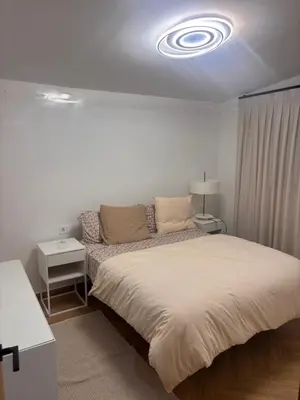 a bedroom with a bed and a couch in it at Apartamento cerca de la playa in Puerto de Sagunto