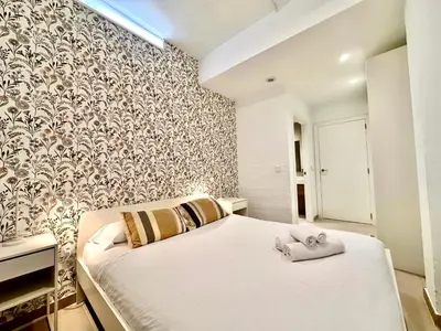 a bedroom with a bed with towels on it at Casa Rosario - Apartamento reformado en El Cabañal in Valencia