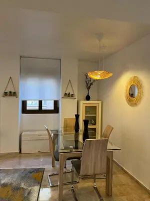 a dining room with a glass table and chairs at La Llum de Serra in Serra