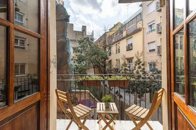 a balcony with two chairs and a table at Prime Location, Bright & Cozy Apartment in Valencia