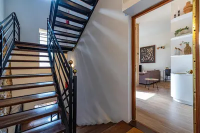 a staircase in a house with a living room at Prime Location, Bright & Cozy Apartment in Valencia