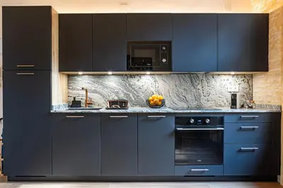 a kitchen with navy blue cabinets and a microwave at Prime Location, Bright & Cozy Apartment in Valencia
