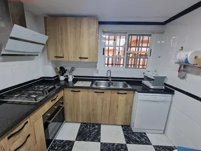 a kitchen with a sink and a stove at House Mare Nostrum in Moncófar