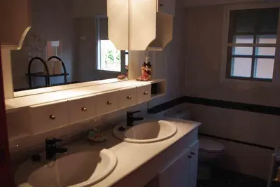 a bathroom with two sinks and a mirror at House Mare Nostrum in Moncófar