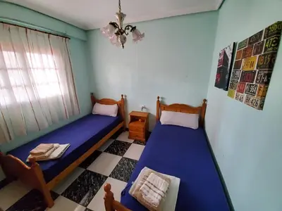 two beds in a room with blue walls at House Mare Nostrum in Moncófar