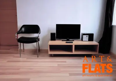 a room with a tv and a chair and a table at ART & FLATS Pleno Centro Valencia in Valencia