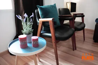 a chair and a table with two cups on it at ART & FLATS Pleno Centro Valencia in Valencia
