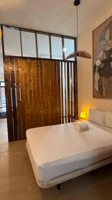 a large bed in a room with a large window at Gran Loft en planta baja en el Centro de Valencia in Valencia