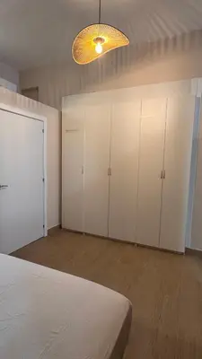 a bedroom with white cabinets and a large bed at Gran Loft en planta baja en el Centro de Valencia in Valencia