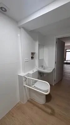 a white bathroom with a toilet and a sink at Gran Loft en planta baja en el Centro de Valencia in Valencia