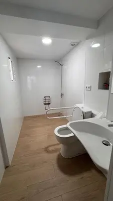 a bathroom with a white toilet and a sink at Gran Loft en planta baja en el Centro de Valencia in Valencia
