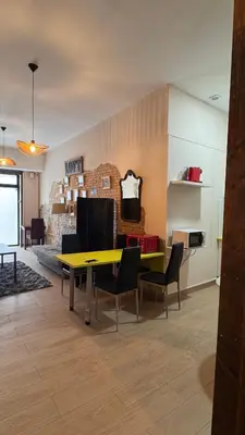 a dining room with a yellow table and chairs at Gran Loft en planta baja en el Centro de Valencia in Valencia