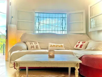 a living room with a couch and a coffee table at El Cortijo a cielo abierto entre montañas in Estivella