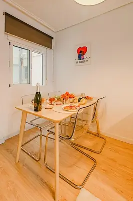 a table with two chairs and a bottle of wine at The Cabanal Beach House - 10 min to ocean, FastWifi, AC, Coffee in Valencia