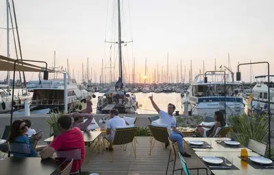 a group of people sitting at tables at a marina at The Cabanal Beach House - 10 min to ocean, FastWifi, AC, Coffee in Valencia