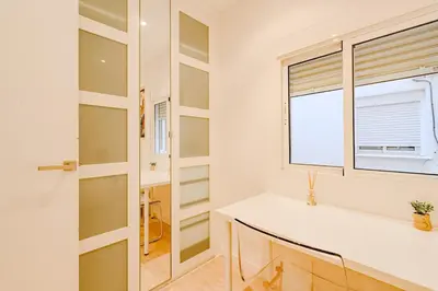 a bathroom with a white counter and a window at The Cabanal Beach House - 10 min to ocean, FastWifi, AC, Coffee in Valencia