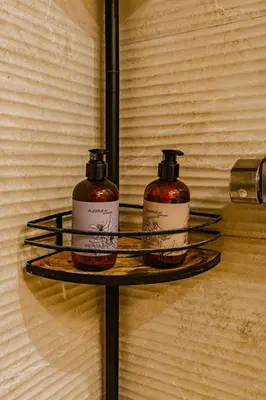 two bottles of soap on a shelf on a wall at The Cabanal Beach House - 10 min to ocean, FastWifi, AC, Coffee in Valencia