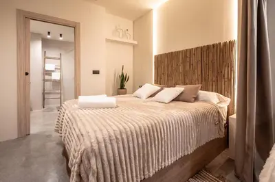 a bedroom with a large bed with two pillows at Suite con terraza - Manolito 1 in Valencia