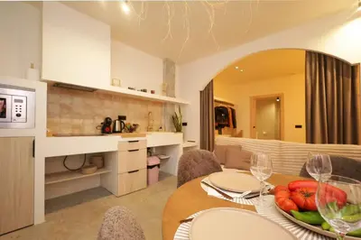 a kitchen and dining room with a table with a bowl of fruit at Suite con terraza - Manolito 1 in Valencia