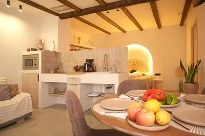 a table with plates of fruit on it in a kitchen at Suite junto Ciudad de las Ciencias - Manolito 2 in Valencia