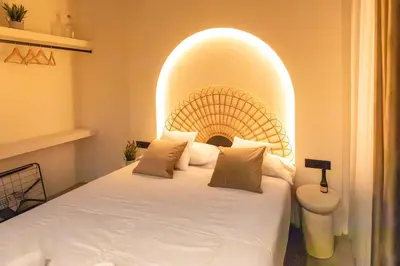 a bedroom with a large bed with an archway at Suite junto Ciudad de las Ciencias - Manolito 2 in Valencia