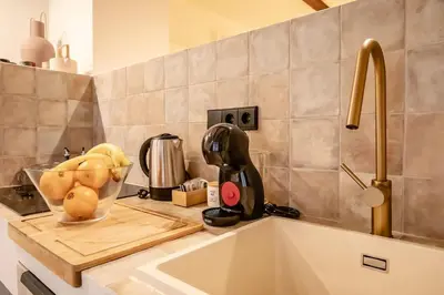 a kitchen counter with a bowl of fruit on a cutting board at Eco suite Puerto - Manolito 3 in Valencia