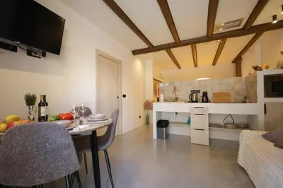 a kitchen and living room with a table and chairs at Eco suite Puerto - Manolito 3 in Valencia