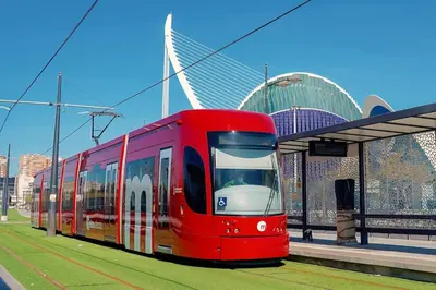 a red train is stopped at a train station at Eco suite Puerto - Manolito 3 in Valencia