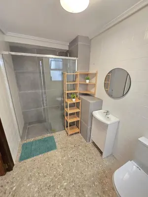 a bathroom with a shower and a toilet and a sink at Simat Malina in Simat de Valldigna