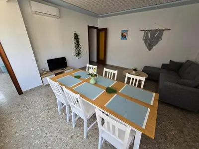 a living room with a table and chairs and a couch at Simat Malina in Simat de Valldigna