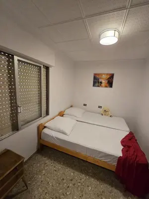 a bedroom with a bed with a teddy bear sitting on it at Simat Malina in Simat de Valldigna