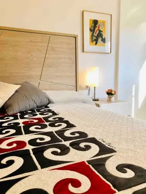 a bedroom with a bed with a carpet on it at Apartamento cerca de playa y Ciudad de Ciencias in Valencia