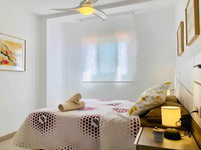 a bedroom with a bed with a teddy bear on it at Apartment near the beach and the City of Sciences in Valencia